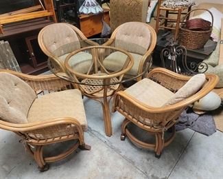 Glass top rattan table with 4 chairs on wheels $125