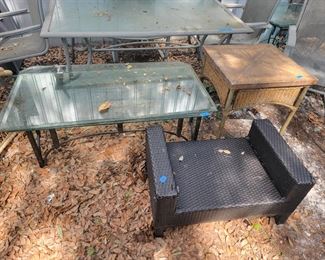 Patio wicker ottoman, has some damage on corner $15, Wicker square table $25, Glass top metal coffee table $75