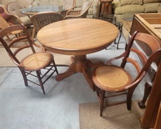 Round table $45
2 wood chairs with wicker seats $25 each