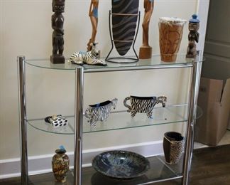 Glass & chrome console; African art pieces