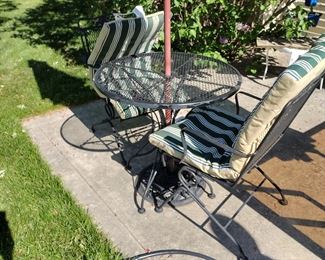 Wrought iron patio set with two wrought iron chairs and umbrella