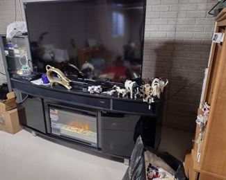 Beautiful flat screen TV on a TV stand with a built-in fireplace