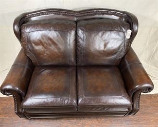 Leather loveseat with nailhead embellishments