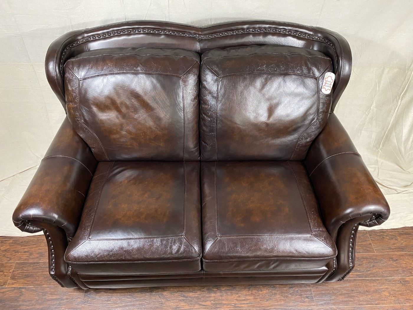 Leather loveseat with nailhead embellishments