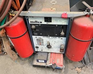 Miller welder on rolling cart designed to hold everything needed for welding