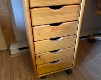 Wooden storage cabinet on wheels