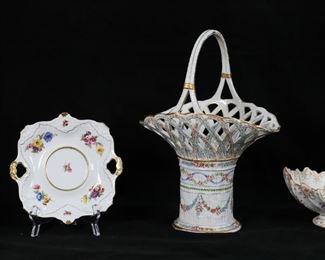 22	3 Pieces German Porcelain	3 piece German porcelain lot, all with floral decoration. Von Schierholz basket, 14 1/2"H; Dresden basket, 10 1/4"L x 7 3/8"H; Kaiser Gloria pattern covered dish with underplate, 5 1/4"H. Losses to gilt painted decoration on rim, handle and base of Von Schierholz basket.
