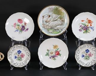 25	8 Pieces German & Austrian Porcelain	8 piece German and Austrian porcelain lot. Herend Chinese Bouquet Green pattern basket, 2"H x 5"-diameter; Hutschenreuther plate with swan decoration after Van Hunnik, 7 7/8"-diameter; set of 3 Schumann plates with floral decoration, each 7 3/8"-diameter; pair of Schmann plates with openwork rims and floral decoration, each 5 5/8"-diameter; O&EG dish with floral decoration, 8 1/4"L.
