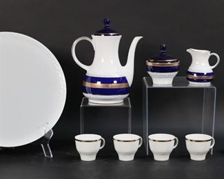 30	12 Piece Bareuther Porcelain Demitasse Set	12 piece Bareuther German porcelain coffee set. Circular tray, coffee pot, lidded sugar bowl, creamer, 4 demitasse cups and saucers. White with cobalt and gilt decoration. All with green Bareuther Waldsassen Bavaria Germany with crown marks except saucers, saucers unmarked. Tray 11 5/8"-diameter, coffee pot 8 1/2"H.
