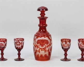 39	7 Piece Etched Ruby Glass Cordial Set	7 piece ruby glass cordial set. Etched with deer and scenic decoration. Decanter and 6 glasses. Decanter 9"H including stopper, glasses each 3 1/2"H. Flakes to rim of decanter, chips to rim of 2 glasses, chips to base of 2 glasses.
