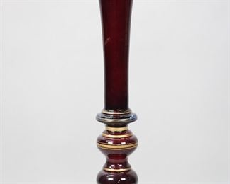 41	Ruby Glass Trumpet Vase	Large ruby glass trumpet vase, with gilt painted decoration. 24 1/4"H x 8"-diameter at top. Losses to gilt decoration.

