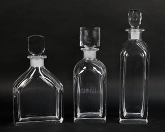 42	3 Orrefors Crystal Decanters	3 Orrefors art glass decanters. 9"H, 9 3/4"H, 11 3/4"H. All signed Orrefors. Chip to corner of largest.
