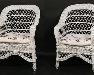 49	Pair of White Wicker Outdoor Lounge Chairs	"Pair of contemporary outdoor lounge chairs. 21st century. Bentwood, painted white wicker, two floral cushions. Staining and wear to cushions. Paint loss and chips to wicker throughout frames of both chairs. 

25"" W x 23 3/4"" D x 37 7/8"" H. 18 1/4"" H seat height (with cushion), arm height 25"" H. Each chair weighs 13 lbs."


