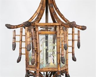 58	Chinoiserie Bamboo Pagoda Form Chandelier	"Chinoiserie bamboo pagoda form chandelier. 20th century. Originally retailed at Bloomingdale's. Bentwood bamboo in pagoda form with six lights enclosed by glass with painted figural and floral scenes. Lighting has not been tested. Separations to three pieces of bamboo along top frame of chandelier. Chips and losses to glass on one pane of chandelier. Splitting and cracking to bamboo on ""arms"" of chandelier. Portion of lower bentwood of chandelier is separated but present. Glass panes are loose in place. 

39 1/2"" W x 61 1/2"" H. 37 lbs.

"
