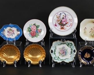 87	14 Pieces Porcelain Including Limoges	13 pieces French, English and American porcelain. 10 pieces French porcelain including Limoges Chinoiserie plate, 7 1/2"-diameter; pair of Editions D'Art dishes, each 5 3/4"L; Godinger Limoges plate, 5 7/8"-diameter; Limoges dish signed T. Burroughs, 6 5/8"L; pair of Limoges gilt painted shell form dishes, each 5 1/4"W; Limoges cobalt ashtray with gilt decoration, 4 5/8"-diameter; pair of Limoges dishes cobalt with bird motifs and gilt decoration, each 3 5/8"-diameter. With a square tray with floral decoration, 5 1/2"W; a pair of Staffordshire dishes, each 3 1/2"-diameter; and an M&R dish, 3 3/8"W.
