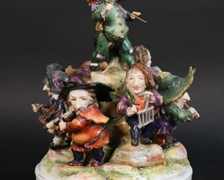 92	German Porcelain Figure Group Musicians	German porcelain figure group, dwarf band. Crown over N mark to the underside. 9"H x 5 3/4"-diameter at base. As is, with chips, repairs and losses throughout.
