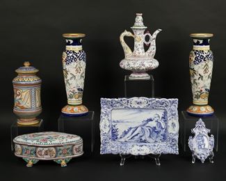 96	7 Pieces Portuguese, Spanish & Italian Majolica	7 pieces faience pottery. Portuguese footed dresser box / jewel casket, 9 3/4'L; pair of candlesticks, each 12"H; Augusta Deruta jar, 9 1/4"H; Berardos Portugal teapot, 9 1/4"H; Fenice Albisola cherub plaque, 6 1/8"L; Fenice Albisola platter, 10 3/4"L. Adhesive residue to dresser box, adhesive residue and scratches to neck of teapot.
