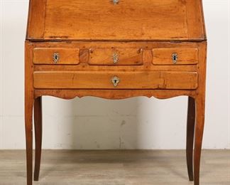 109	Louis XV Provincial Bureau de Pente Writing Desk	"Louis XV Provincial bureau de pente writing desk. French, 19th century. Desk in slant front form with four outer drawers, the interior with leather inset writing surface and four drawers. Interior of desk contains hidden compartment concealed with sliding panel.  Two original keys are included. Faux central outside drawer. Wear and staining to leather inset. Wear, scuffs and scratches throughout interior of desk. Chips and losses to top shelves on interior of desk. Chips and nicks to wood on legs of desk. Wear to wood throughout exterior of desk. Slant front lid does not close completely flush. 

32 1/8"" W x 16 5/8"" D x 38 1/2"" H. 52 lbs."
