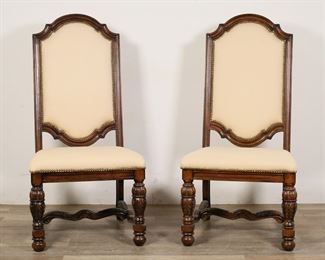112	Pair of Louis XIV Baroque Style High Back Chairs	"Pair of Louis XIV Baroque style high back chairs. Heavily carved legs and stretcher in scroll and acanthus forms, nailhead trim, cream-colored upholstery. Wear and light pilling to upholstery. Gray scuffs to wood on back legs of one chair. Small chips, nicks, scuffs and marks to wood throughout legs and frames of both chairs. 

 24"" W x 27 5/8"" D x 48 1/4"" H. 54 lbs total."
