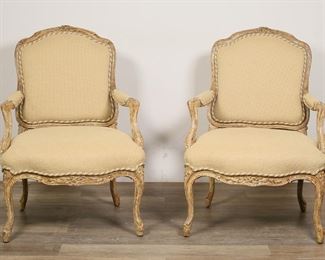 115	Pair of Minton-Spidell Louis XV Style Armchairs	"Pair of Louis XV style fauteil-form armchairs produced by Minton-Spidell. LA, CA, 20th century. Carved legs, arm and frame with beige upholstery. Wood of both chairs executed in a distressed finish. Minton-Spidell labels on undersides of both chairs. Fading, pilling, wear and losses to upholstery on both chairs. Stain to upholstery on seat of one chair. 

26 1/4"" W x 28 1/2"" D 36 1/2"" H. Seat height 18"" H. Arm height 23 1/2"" H. Each chair weighs 18 lbs."
