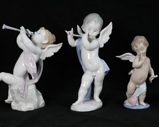 153	5 Lladro Porcelain Figurines Angels & Cupid	5 Lladro porcelain angel and Cupid figurines. Cupid 6311, Mime Angel 4949, 3 piece angel band (Lute 1231, Clarinet 1232, Flute 1233). Mime Angel 8 1/2"H, Angel Playing Flute 10 1/4"H. Clarinet detached, end of flute chipped.

