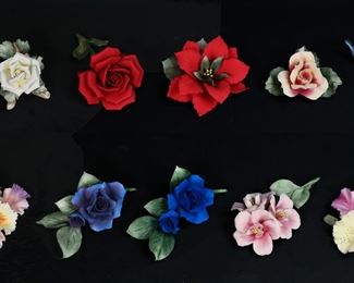 164	11 Capodimonte Uno Alla Volta Porcelain Flowers	11 Capodimonte Italian porcelain Uno Alla Volta flowers. Red rose, cherry blossoms, magenta and yellow iris, blooming iris, calla lilies with bird, poinsettia, white rose, magenta and white rose, pink and white rose, blue rose, purple rose. All signed Uno Alla Volta Capodimonte Made in Italy. Red rose 7 1/2"L. Pink cherry blossoms repaired at stem, minor chips to petals; minor chips to petals of magenta and yellow iris; flakes to petals blooming iris; calla lilies chip at base of leaves; magenta rose roughness to edges of petals; blue rose chips to one petal.
