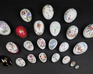 169	23 Limoges Porcelain Egg Boxes	23 Limoges porcelain egg form trinket boxes. Hand painted and transfer decoration, including flowers, Chinoiserie, courting scenes, butterflies, birds, cobalt and gilt footed box. Largest box 5"L x 3 1/4"H, cobalt box 3 5/8"H. All with various Limoges marks to the undersides. Butterfly box lines and chip to lid, box with bird and fruit basket chip to rim of lid, box with pink flowers chip to rim of lid.
