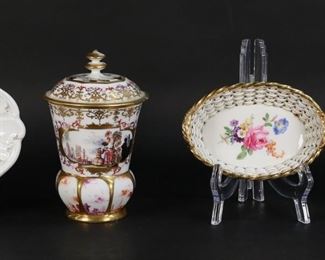 175	4 Pieces Meissen Porcelain	"4 pieces Meissen porcelain. Basket, with hand painted flowers, blue crossed swords mark and incised W 11 A to the underside, 5 1/2""L; oval dish / underplate, with hand painted flowers, blue crossed swords mark, 7 7/8""L; dish with hand painted urn and grapes, dot period blue crossed swords mark, 5 1/4""-diameter; lidded vase, with Chinoiserie harbor scenes, blue crossed swords mark and signed K to interior of lid and underside. 6 3/8""H.
Losses to gilt decoration on underplate, losses to gilt decoration on rim of urn dish and minor losses to painted decoration; paint loss throughout vase and lid, losses and repairs to finial on lid, chips and repairs to rim of lid, chips and repairs to rim of vase, repairs throughout body of vase."
