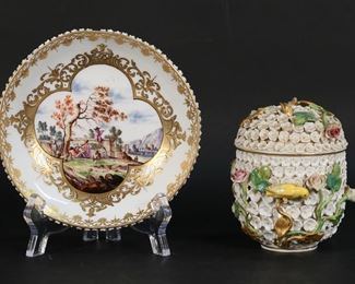 176	Meissen Snowball Cup & Associated Saucer	Meissen porcelain Schneeballen lidded cup, with associated underplate. Cup with blue crossed swords mark, underplate with illegible blue mark on one foot. Cup 4"H, saucer 5 1/4"-diameter. Cup missing handle, chips to flowers and stems throughout cup and lid, both birds missing tail feathers, finial missing from lid; saucer chip along rim, leaves chipped, blue flowers chipped and missing, feet chipped.
