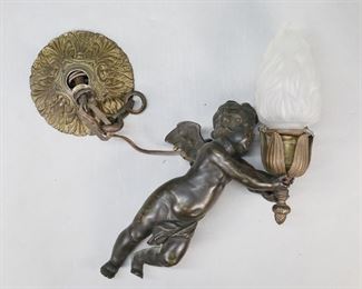 180	Bronze Cherub Ceiling Fixture	Bronze cherub one light hanging light fixture. Frosted glass flame shade. 16"L including shade. Chips to rim of shade under fitting, collar for shade missing one screw and one screw replaced, scratches and losses to patina on cherub, hole in side of cherub.
