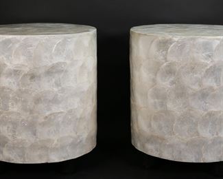 182	Pair of Contemporary Capiz Shell Side Tables	"Pair of contemporary Capiz shell side tables. Philippines, 21st century. Handcrafted cylindrical form tables with applied Capiz shell finish and cylindrical feet. Manufacturer labels on underside of tables. Light wear to underside of tables.  

16 5/8"" H x 14 7/8"" diameter. 24 lbs total. 
"
