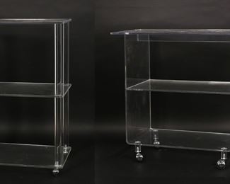 185	Two Plastic Works Mid Century Modern Tier Tables	"Two Mid Century Modern plastic or Lucite tiered side tables produced by Plastic Works. 20th century. Each with two lower tiers, all set on silvertone casters. ""Plasticworks!"" label on lowest tier on both  tables. Wear, scuffs, and scratches throughout plastic of both tables. 

Widest table: 30 1/8"" W x 16"" D x 29 1/4"" H. Smaller table: 18"" W x 14"" D x 30"" H. 46 lbs total."
