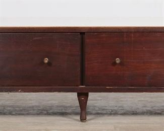 191	Paul McCobb Style Mid Century Modern Low Credenza	"Mid Century Modern low credenza in the style of Paul McCobb (Medford, MA, 1917-1969). 20th century. Removable hourglass-form drawer pulls and feet, two drawers, white laminate top. No apparent maker's marks or labels. Scratches and marks throughout laminate top. Tarnishing to metal of drawer pulls. Chips and losses to veneer on left, right, and front edges of credenza. Losses to foot caps on feet.

59 1/4"" W x 17 3/4"" D x 13 1/2"" H. 77 lbs."
