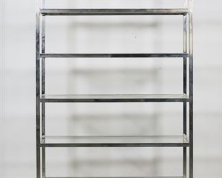 196	Milo Baughman Style Mid Century Chrome Etagere	"Mid Century Modern etagere in the style of Milo Baughman (Goodland, KS, 1923-2003). 20th century. Chrome frame with six inset glass shelves. No apparent labels or maker's marks. Fleabites and small losses to glass on corners of shelves. Large chip and loss to glass on corner of one shelf. Scuffs, scratches and wear throughout glass. Scuffs and wear throughout chrome. 

42 1/8"" W x 16 1/8"" D x 76 1/8"" H. 110 lbs total."
