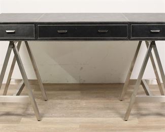 200	Ethan Allen Mid Century Modern Style "Lloyd" Desk	"Mid Century Modern style ""Lloyd"" desk produced by Ethan Allen. 21st century. Campaign form desk with removable black leather top with three drawers resting on chrome sawhorse bases. Ethan Allen label on inside of left drawer. Light scratches, scuffs and wear to leather to top of desk. Fraying to threading on top of desk near front left corner. Wear, scratches and scuffs to metal of bases. Pins which hold top to base are missing from left track on underside of top. 

57 1/2"" W x 27 5/8"" D x 31"" H."
