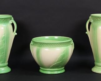 226	Set of 3 American Art Pottery Vases	Set of 3 American pottery vases. Each marked on the underside USA and 157 /, possibly Robinson Ransbottom. Pair of 2 handled vases, each 12"H, with a matching planter, 7 1/8"H x 8 1/2"-diameter at top. Crazing to undersides of both vases, crazing to base and rim of one vase and base of planter, firing cracks to underside of planter and glaze pops to all, one vase misshapen at base.
