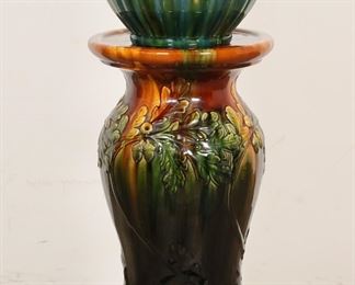 228	Pottery Jardiniere & Pedestal	American pottery jardiniere and pedestal. Both unsigned, jardiniere possibly Robinson Ransbottom, pedestal possibly Roseville. 29 1/2"H total (jardiniere 9"H x 10"-diameter). Chip to base of jardiniere, scratches to top of pedestal, line to base of pedestal and chips, glaze misses and firing cracks to base.
