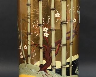 230	Chinese Porcelain Umbrella Stand	Chinese porcelain umbrella stand. Gilt ground with hand painted decoration of bamboo, birds and cherry blossoms. 17 1/2"H x 7 5/8"-diameter. Minor scratches.
