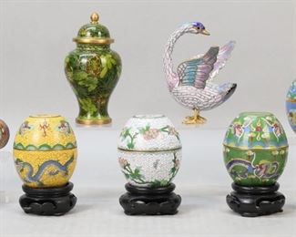 239	13 Pieces Chinese Cloisonne & Champleve	12 pieces Chinese cloisonne: 4 egg form boxes, 3 with dragon motif and one with cherry blossoms, 1 missing wooden stand, each 2 3/4"H without stands; 2 miniature ginger jars, larger 4 1/4"H; 2 miniature vases, larger 3"H; miniature watering can, 2 1/8"H; egg,1 1/2"H not including wooden stand; owl figurine, 2 1/8"H; goose figurine, 4"H. With a hexagonal champleve box, 2 1/4"H. Rim of blue egg box bent, finial on lid of watering can bent.
