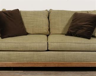 247	Tommy Bahama Style Sofa By Lexington Home Brands	"Tommy Bahama style sofa by Lexington Home Brands. Hildebran, NC, 21st century. Green upholstery and carved wooden palm and reed designs on arms. Two additional brown throw pillows included. Lexington Home Brands labels on seat underneath right seat cushion.  Wear and light pilling throughout upholstery of sofa. Chips and scuffs to wood on feet. Chips and losses to wood on carved portions of arms. Tears to fabric lining on underside of sofa. 

91"" W x 37"" D x 33"" H. 163 lbs."
