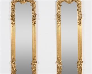 256	Pair of Rococo Revival Style Hall Mirrors	"Pair of Rococo Revival style hall mirrors. 20th century. Gilded composite frames with floral motifs. Light wear and scratches to frames of each mirror. 

40 3/8"" x 11 1/2"". Each mirror weighs 8 lbs."
