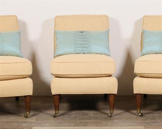 257	3 Calico Corners Custom Slipper Chairs	"3 Calico Corners custom slipper lounge chairs. Kennett Square, PA, 21st century. Edwardian style chairs with yellow upholstery and reeded front legs on caster. Light blue throw pillows included with each chair. Calico Corners labels on seats underneath cushions. Wear and fading throughout upholstery of all chairs. Nicks, marks and small chips to wood on back legs of  all chairs. Wear and small stains to throw pillows. 

23"" W x 32 3/8"" D x 33 7/8"" H. 108 lbs total.

"
