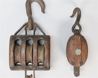 287	2 Block & Tackle Pulleys	2 vintage wood block and tackle pulleys. Larger 6 5/8"W. Both with splits and losses to wood and rusting to iron.

