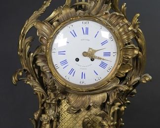 297	Japy Freres Gilt Bronze Wall Clock	Gilt bronze cartel style wall clock. Acanthus leaf motif, enamel face with cobalt numerals. Works with Japy Freres mark, face marked Girard, 22 rue Vivienne Paris. 23 1/2"L. Minor chipping to face around keyhole, line to face at 15 seconds. Untested.
