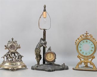 300	3 Decorative Clocks	"Patinated metal figural clock lamp with art nouveau woman and lamp post, clock marked made in USA, 16""H including finial; French silver tone pocket watch on figural silverplate stand with trees and horse, stand 8""H; gilt bronze clock with turquoise enamel decoration (no works or hands), 9 1/2""H.

Lamp working, clock not running, right leg of clock cracked on lamp, losses to patina throughout, lamp fitting re-soldered; pocket watch untested, no crystal, losses to dial, tarnishing and losses to silverplating on stand; gilt bronze clock no works or hands, losses to enamel throughout, scratches to face."
