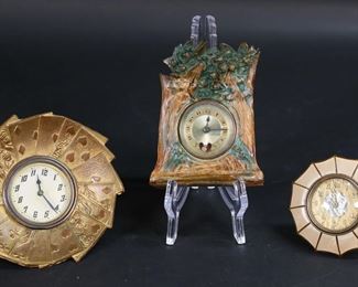 303	3 Desk Clocks	3 desk clocks. French resin clock, works marked JF  (Jaccard Fereres), case marked France and Cornells Paris, 4 5/8"H; Lux Clock Co. Bakelite umbrella clock, 3 1/2"-diameter; brass playing card clock, 5 1/8"-diameter.  Resin clock chipped and cracked  throughout and piece detached at top, umbrella clock creases to face and minor chips to umbrella, playing card clock some discoloration to brass.
