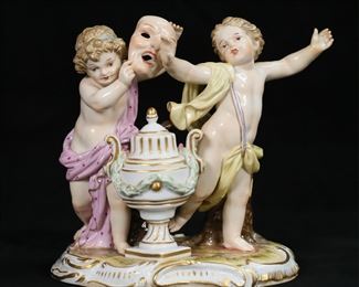 312	Meissen Porcelain Figure Group Cherubs With Mask	Meissen porcelain figure group, putti with mask. Blue crossed swords mark and incised H39 and 145 to the underside. 5"L x 4 5/8"H.
