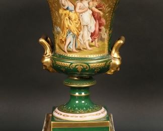 316	Vienna Style Hand Painted Porcelain Urn	Vienna style porcelain lidded urn. Hand painted scene of three women with baskets of flowers, signed C. Forster. Gilt painted decoration and figural handles. Titled illegibly, with Vienna style "beehive" shield mark to the underside. 13 1/8"H. Losses to gilt painting on base and throughout.
