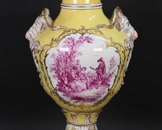 318	Carl Thieme Potschappel Porcelain Urn	Potschappel Carl Thieme Meissen style German style porcelain urn. Yellow ground, hand painted magenta flowers, with gilt painted decoration and applied porcelain flowers, molded figural goat form handles. Footed pedestal, openwork lid with applied porcelain flowers. Sevres style interlaced double L with crown and central CT mark. 23 1/2"H. Chips to flowers and leaves on lid, firing crack to underside of pedestal.
