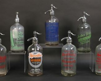 329	7 Vintage Glass Seltzer Bottles Pennsylvania & NJ	7 vintage glass seltzer bottles / soda siphons. Pennsylvania: Harvilla's Seltzer John Harvilla, A. Marinaro, Indian Rock Beverage Company Inc. Philadelphia, Sheffield Bottling Co. Philadelphia; New Jersey: Tasty Bottling Co. Trenton, Farber Bros. Newark, Williams Grade A Lexington Bottling Works Clifton. Harvilla's bottle 11"H. Minor losses to painted lettering on Williams, Sheffield and Farber bottles, Williams bottle chip to bottom.
